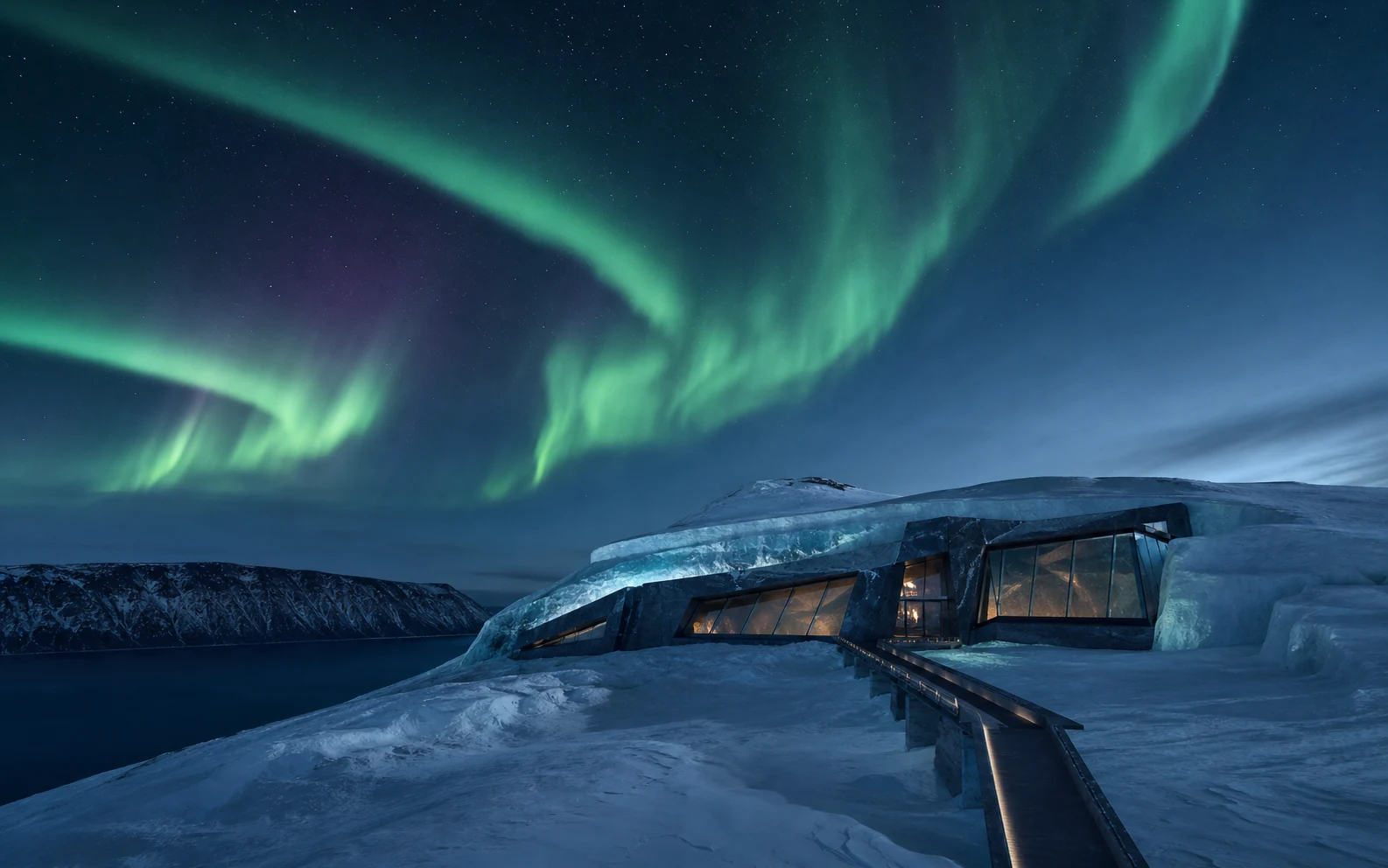 A low polar lodge embedded in snow beneath sweeping green aurora